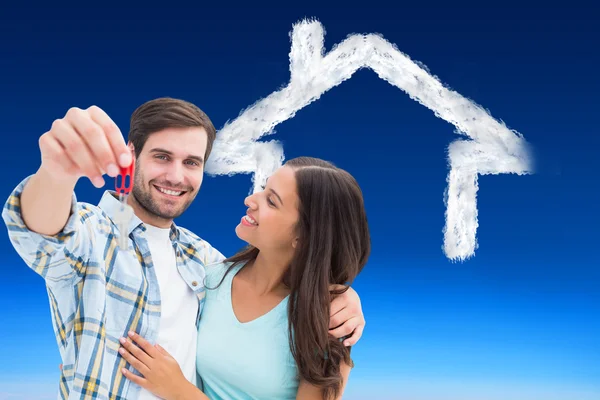 Happy young couple showing new house key — Stock Photo, Image