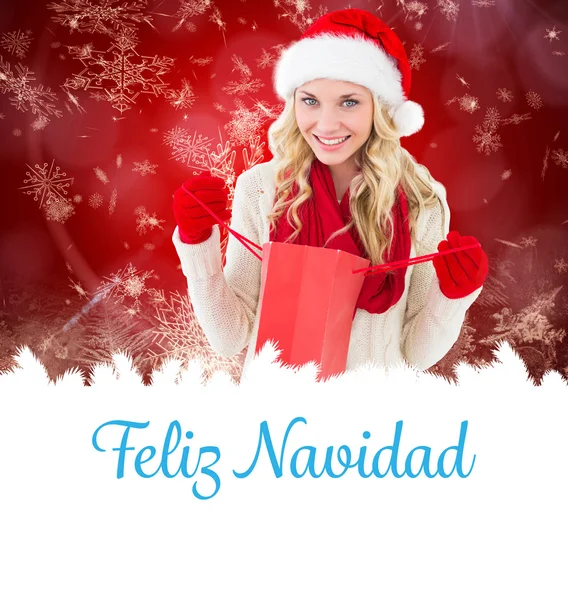 Happy festive blonde with shopping bag — Stock Photo, Image