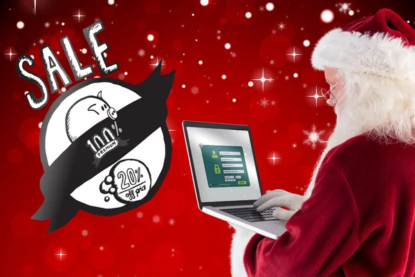 Papai Noel usa um laptop — Fotografia de Stock