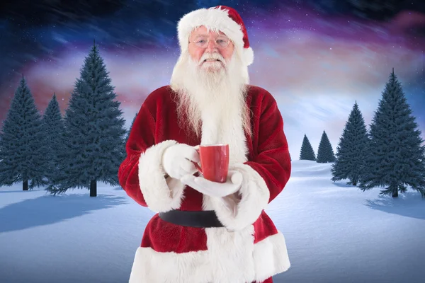 Santa holds red cup — Stock Photo, Image