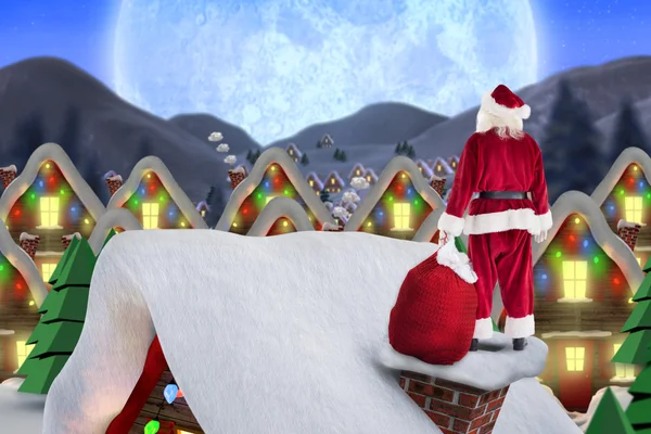 Santa op huisje dak — Stockfoto