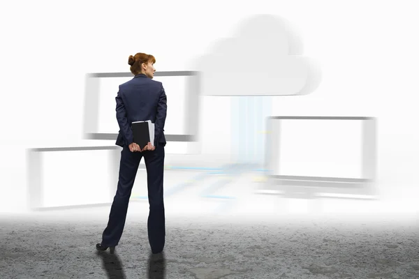 Businesswoman looking against cloud computing graphic — Stock Photo, Image