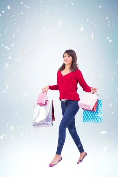 Excited brunette with shopping bags — Stock Photo, Image