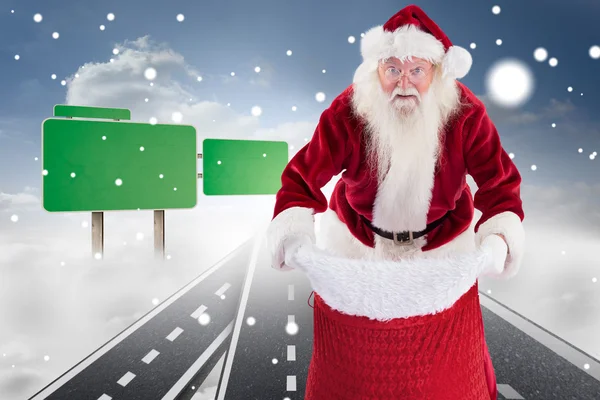 Santa open bag against roads — Stock Photo, Image