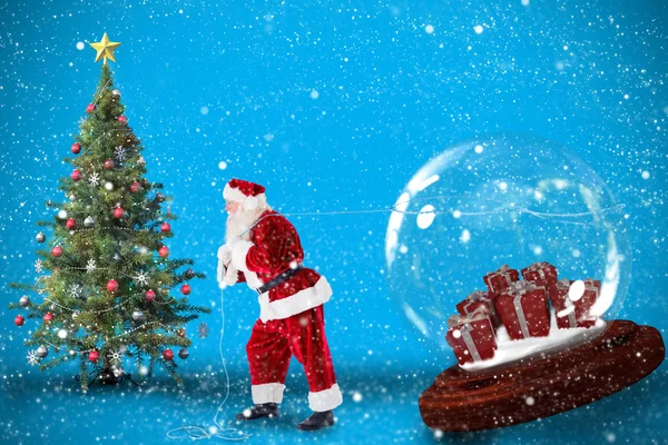 サンタさんのプレゼントの雪の世界を引っ張っての合成画像 — ストック写真