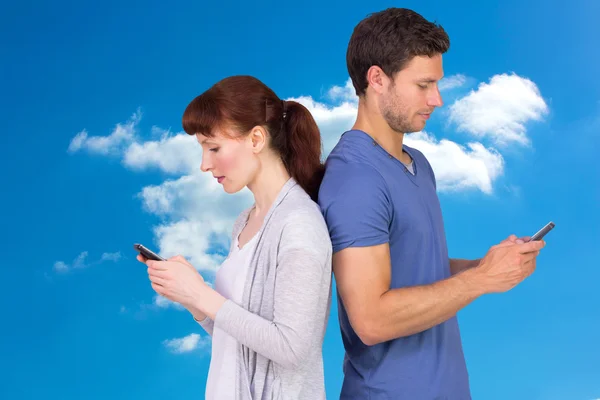 Couple both sending text messages — Stock Photo, Image