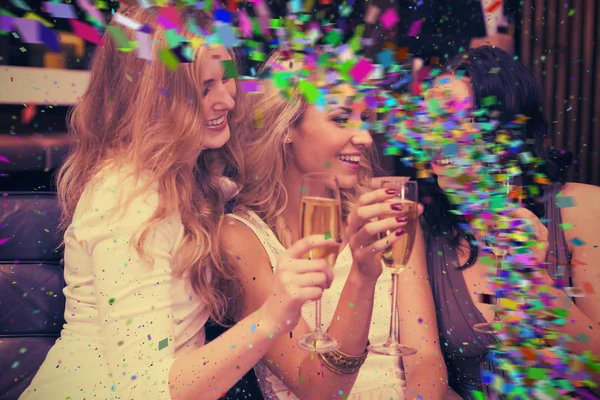 Composite image of happy friends drinking champagne together — Stock Photo, Image