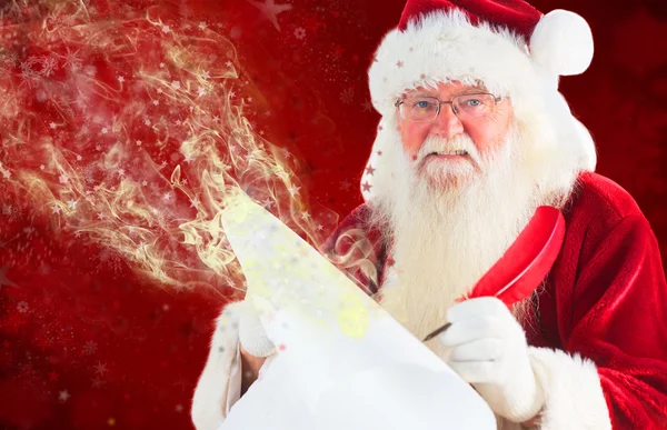 Santa claus schrijven op scroll — Stockfoto