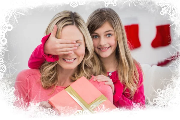 Girl hiding gift from mother — Stock Photo, Image