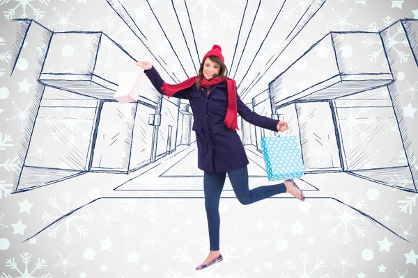 Composite image of festive brunette holding shopping bags — Stock Photo, Image