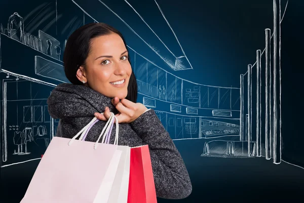 Smiling woman holding shopping bag — Stock Photo, Image