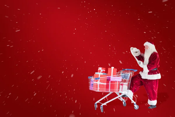 Santa pushes shopping cart — Stock Photo, Image