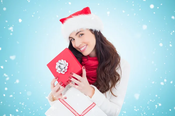 Smiling brunette holding christmas gifts Royalty Free Stock Photos