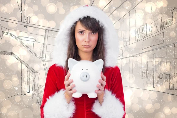 Sad festive woman holding piggy bank Royalty Free Stock Photos