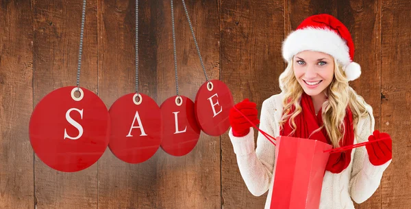 Festive blonde with shopping bag — Stock Photo, Image