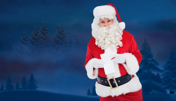 Happy santa holding paper and pen — Stock Photo, Image