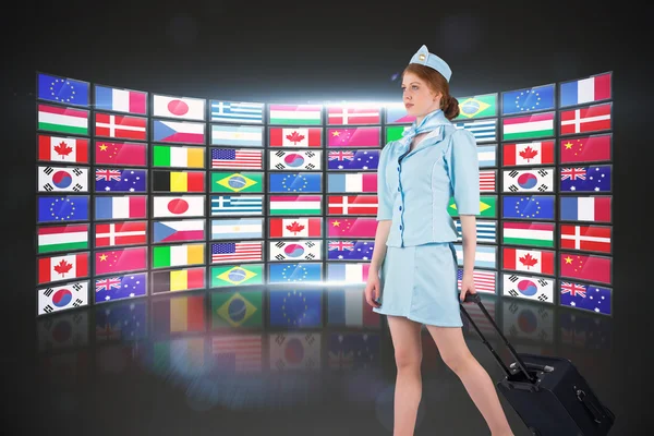 Pretty air hostess pulling suitcase — Stock Photo, Image