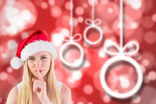 Composite image of festive blonde keeping a secret — Stock Photo, Image