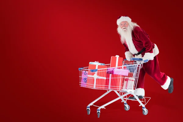 Papai Noel monta em um carrinho de compras — Fotografia de Stock