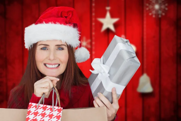 Composite image of woman with gifts — Stock Photo, Image