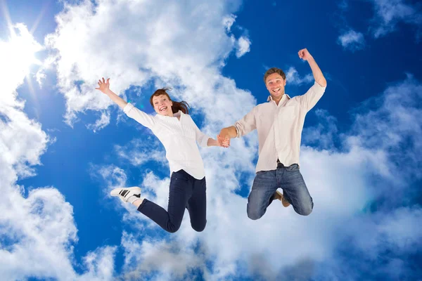 Couple jumping and holding hands — Stock Photo, Image