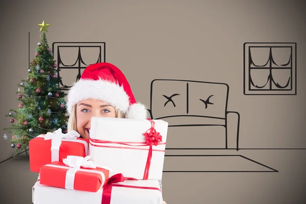 Festive blonde holding pile of gifts — Stock Photo, Image