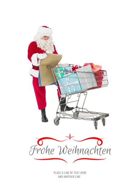Santa přináší dárky s vozík — Stock fotografie