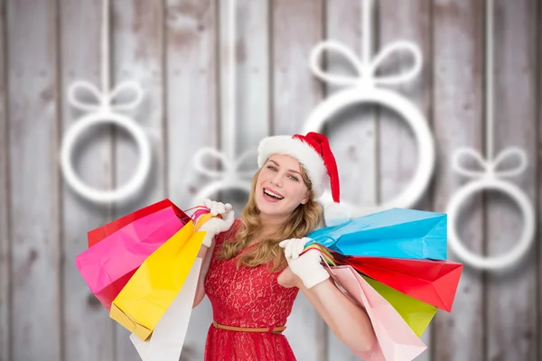 Rubia excitada en santa hat celebración de compras — Foto de Stock