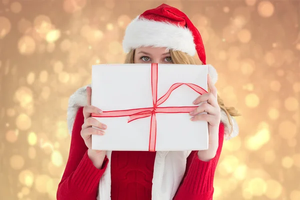 Blonde woman hiding behind a gift — Stock Photo, Image