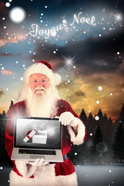 Santa Claus prezentuje laptopa — Zdjęcie stockowe