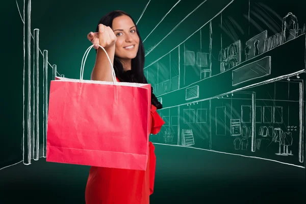 Woman standing with shopping bag — Stock Photo, Image