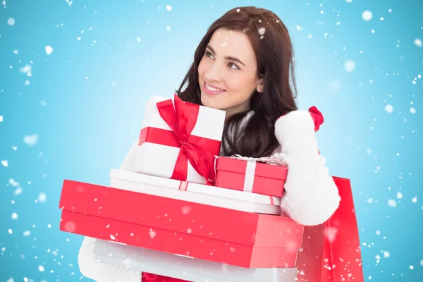 Happy brunette holding christmas gifts — Stock Photo, Image