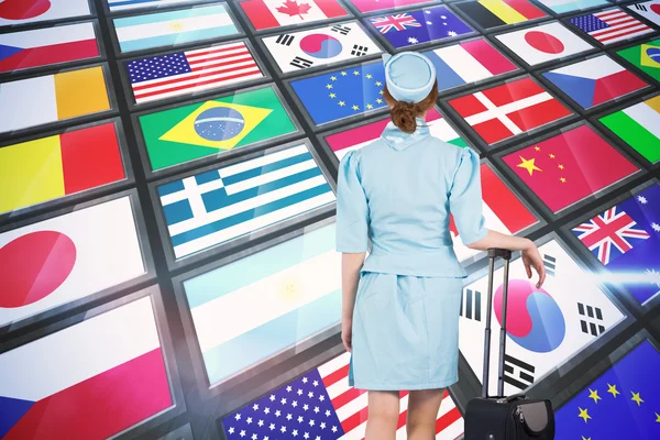 Air hostess leaning on suitcase — Stock Photo, Image