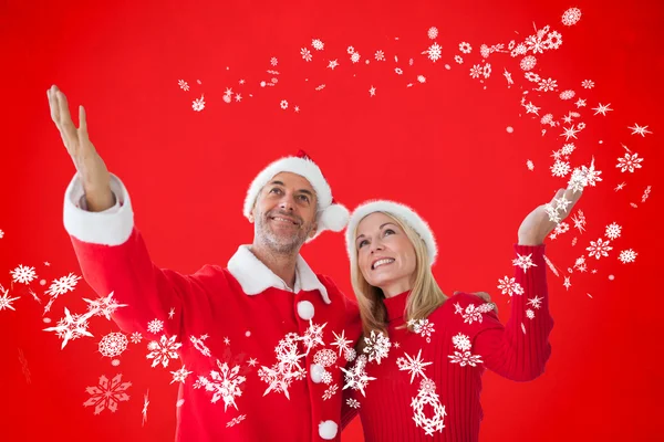 Festive couple against red — Stock Photo, Image