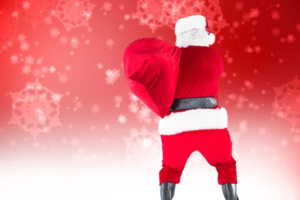 Rear view of santa holding a sack — Stock Photo, Image