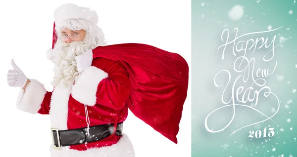 Santa met zijn zak en duimschroef opwaarts — Stockfoto