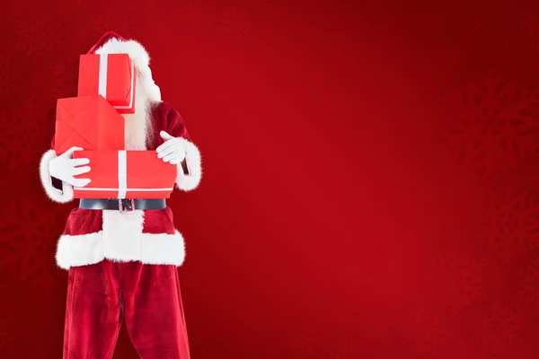 Santa cubre su cara con regalos — Foto de Stock