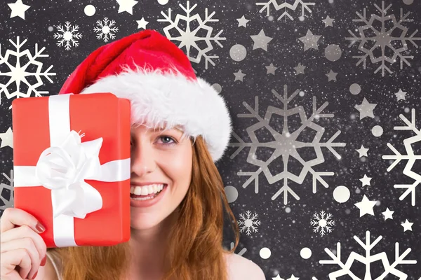 Festive redhead holding gift — Stock Photo, Image