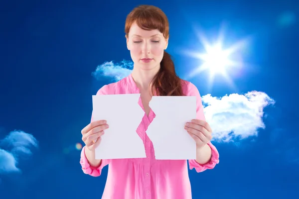 Composite image of woman holding torn sheet of paper — Stock Photo, Image