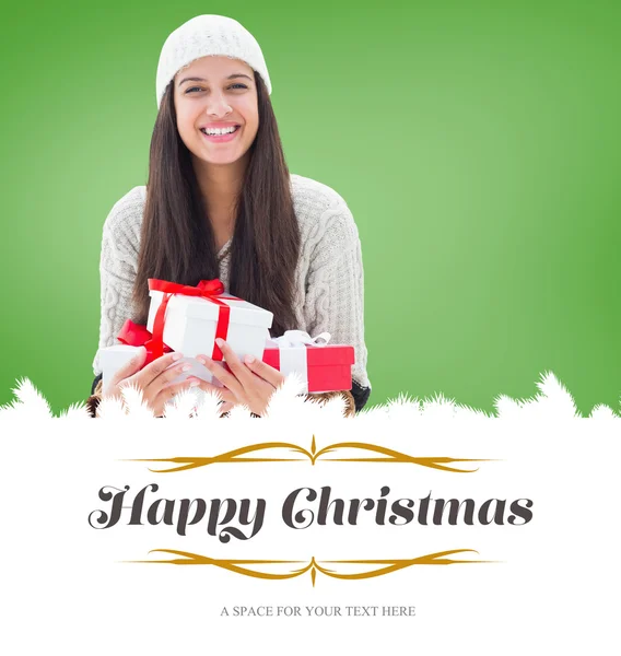 Festive brunette holding gifts — Stock Photo, Image