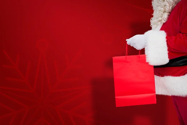 Imagen compuesta del padre Papá Noel sosteniendo una bolsa de compras — Foto de Stock