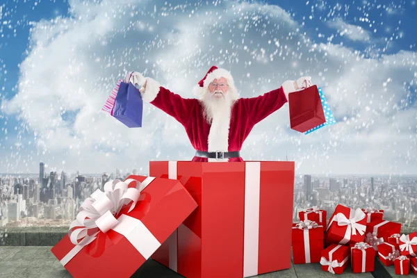 Santa standing in large gift — Stock Photo, Image