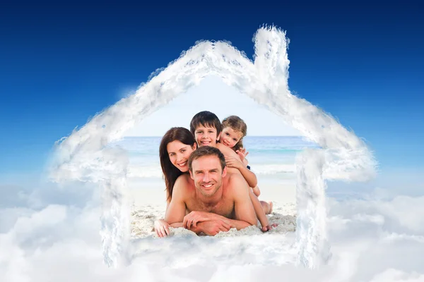 Composite image of family on the beach — Stock Photo, Image