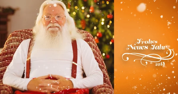 Smiling santa without his jacket relaxing — Stock Photo, Image