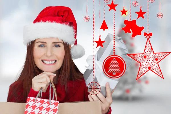 Composite image of woman with gifts — Stock Photo, Image