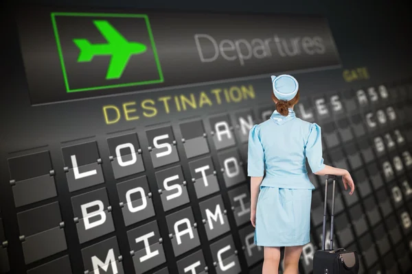 Air hostess leaning on suitcase — Stock Photo, Image