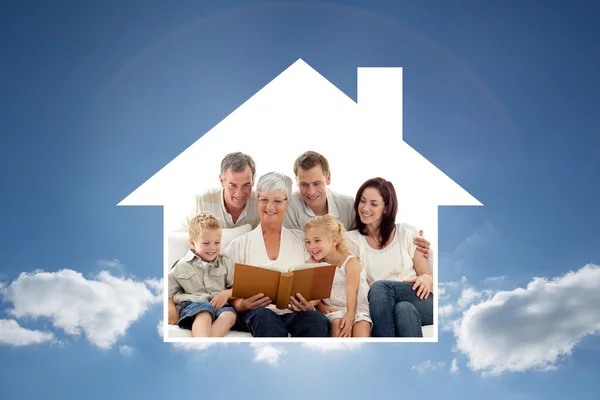 Grandmother reading book to family — Stock Photo, Image