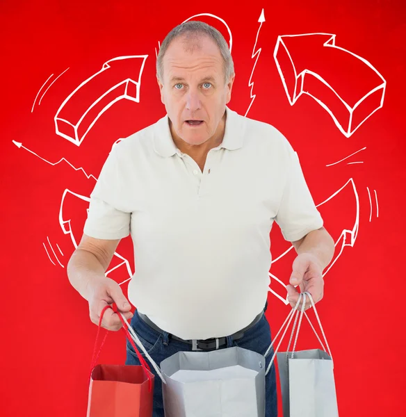 Shocked man holding shopping bags — Stock Photo, Image