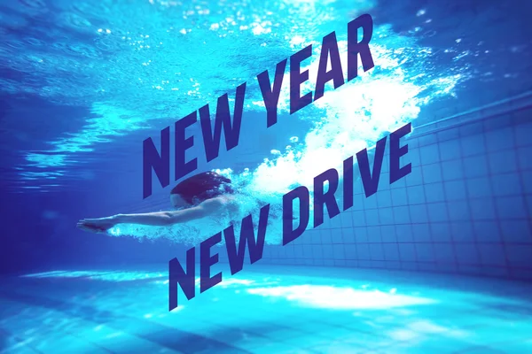 Athletic swimmer smiling at camera underwater — Stock Photo, Image