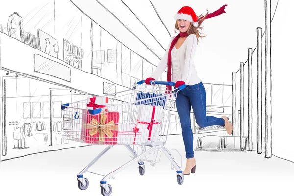 Blonde pushing trolley full of gifts — Stock Photo, Image